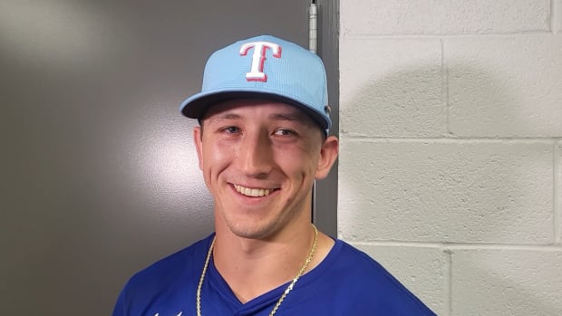 Texas Rangers top prospect Wyatt Langford reacts to hitting his first spring training home run in the seventh inning of the club's game against the San Francisco Giants at Scottsdale Stadium
